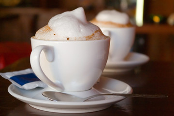 two cappuccino cups with milk foam