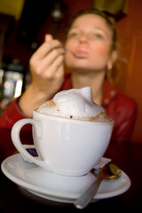 cappuccino with milk skin with girl at background