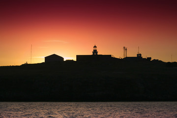 silhouette of an island and lighthouse