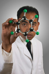 eye for chemistry in lab coat close up white bg