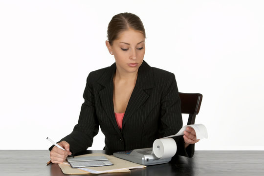 Business Woman Balancing Checkbook At Desk