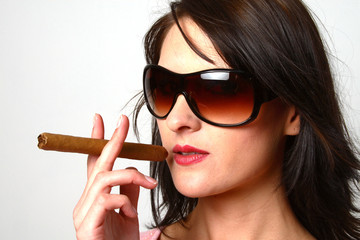 dark hair woman smoking a cigar with sunglasses