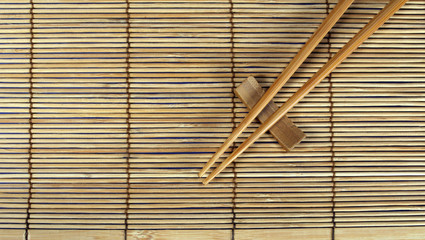 chopsticks on bamboo mat