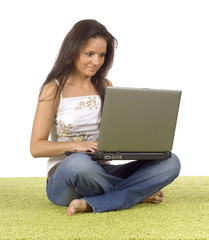 Naklejka premium young woman with laptop on the green carpet