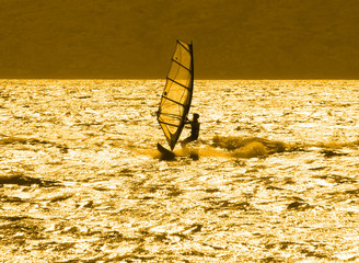 lone windsurfer at sunset