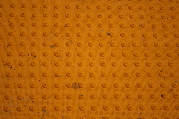 yellow dimpled concrete background