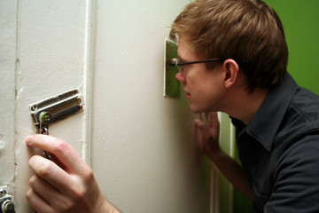 man looking through peephole