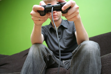 man on couch playing video games