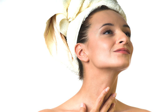 woman in towel apply cream