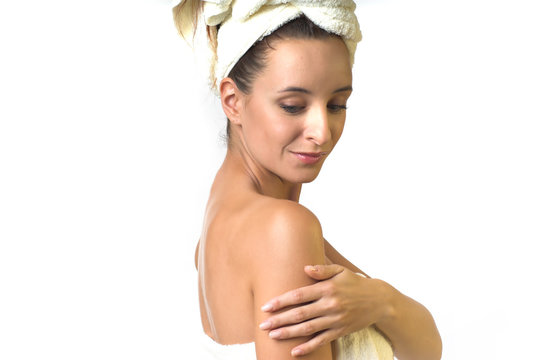 woman in towel apply cream