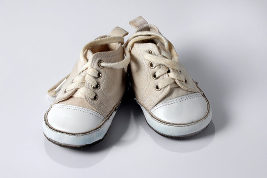 baby sneakers over white background