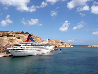 ship off the coast of malta with ocean and clouds