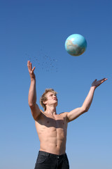young muscular man playing with a globe