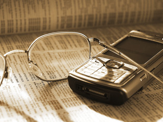 mobile phone and glasses on phone directory