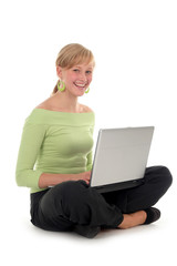 young woman sitting on floor using laptop