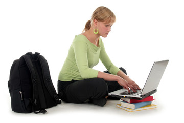 female student sitting on floor using laptop