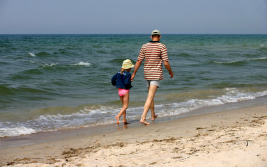 father and daughter on the beach