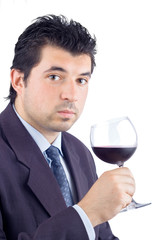 man in a suit tasting wine