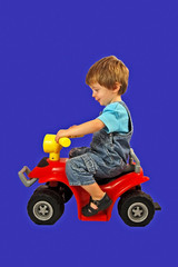 little boy on a toy bike