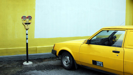 parking meter with yellow car