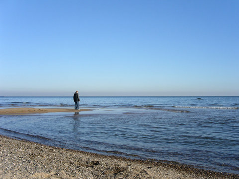lone person staring out to sea