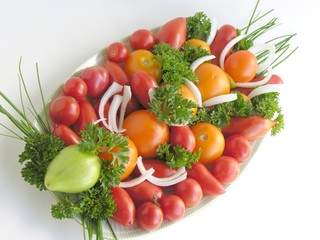 colorful tomatoes with onion's green leaves