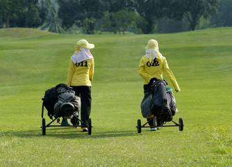 two caddies on a golf course