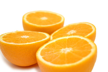 Fototapeta na wymiar half-cut oranges isolated on white - shallow dof