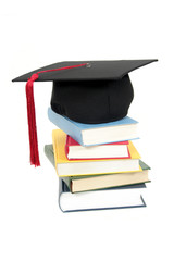 graduation cap on stack of books