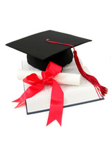 graduation cap and diploma on a book