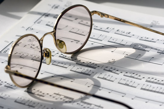 pair of glasses on sheet music 2