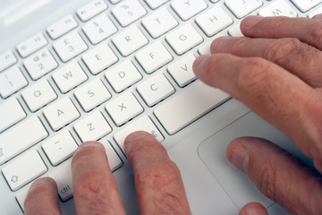 elderly man using laptop