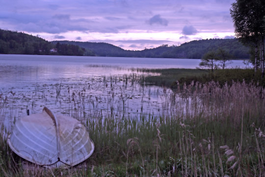 Twilight view of Landvetter Lake, Sweden, with upturned boat