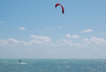 kite surfer with a red surf kite