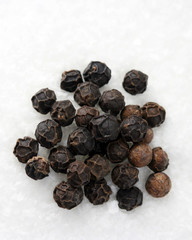 black and brown whole peppercorns