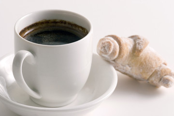 coffee and croissant on white plate isolated