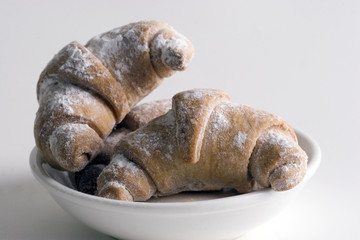 croissant on white plate isolated on white backgro