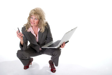 business woman juggling cellphone and laptop