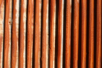 a rusty corrugated iron fence