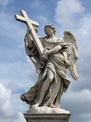 angel figure with a stone cross
