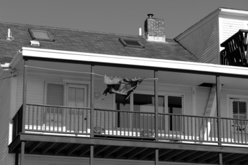 long coat dries in the sun at new england fishing village