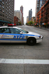 police car crossing empty city street