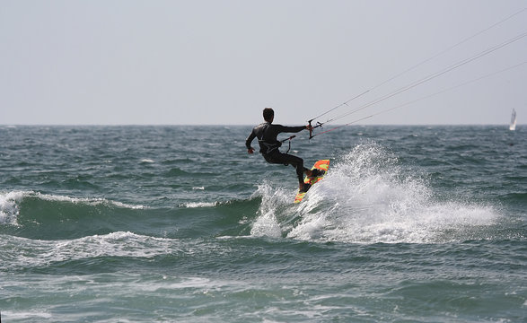 kitesurfer with a sail boat