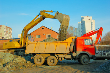 excavator and truck move earth