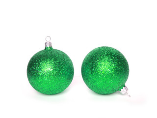 two green christmas balls over white background