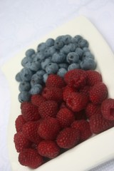 raspberries and blueberries on white plate