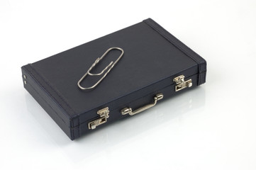 black suitcase and paper clip
