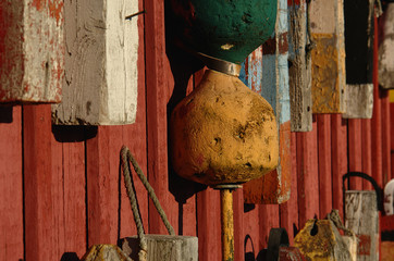 old buoys on wall at fishing shack