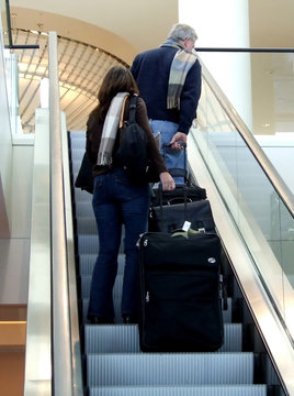 couple ascending the escalator