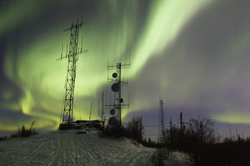 scientific antennas under night sky with northern